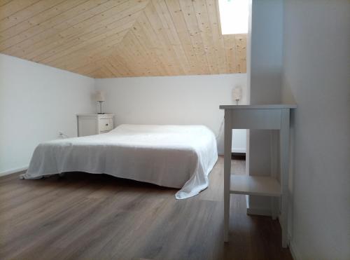 a bedroom with a bed and a table and a desk at Pratofiorito Apartment in Caslano