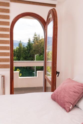 a bedroom with a bed and an open window at Riverside Lim in Plav