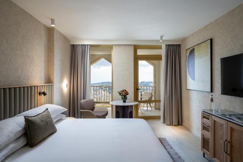 a hotel room with a large bed and a balcony at Leonardo Plaza Hotel Jerusalem in Jerusalem