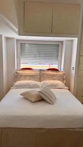 a bed in a room with a large window at Messapia Homes in Mesagne