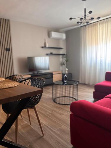 a living room with a red couch and a table at Las Casas de Lola in Candeleda