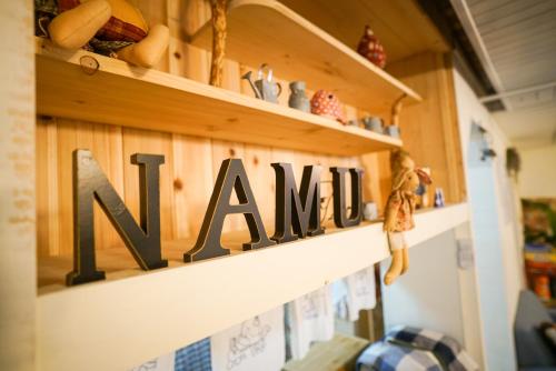 a shelf with a sign that readsamine at Suncheon Namu Guesthouse in Suncheon