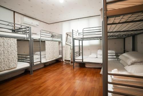 a room with four bunk beds in it at Suncheon Namu Guesthouse in Suncheon