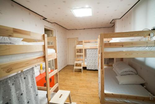a dorm room with bunk beds in it at Suncheon Namu Guesthouse in Suncheon