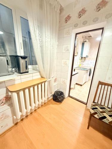 a room with a kitchen with a door and a table at Одноместный номер на ключ в хостеле Single Hostel Room in Chişinău