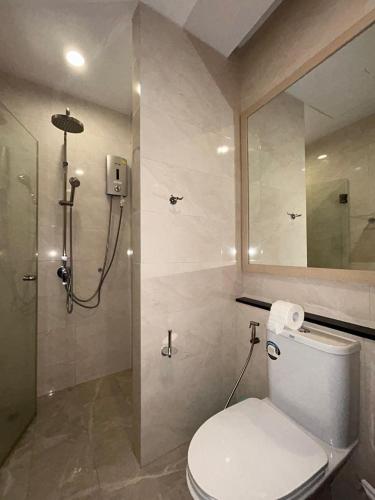a bathroom with a shower with a toilet and a shower at Blue Sky Condo by Palmetto Karon in Ka Rorn