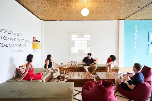 a group of people sitting on couches in a room at Outpost Ubud Nyuh Kuning in Ubud