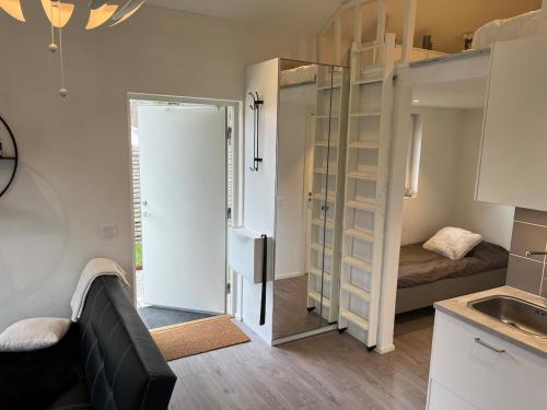 a small room with a bed and a kitchen at Granat's Gästehouse in Höllviken