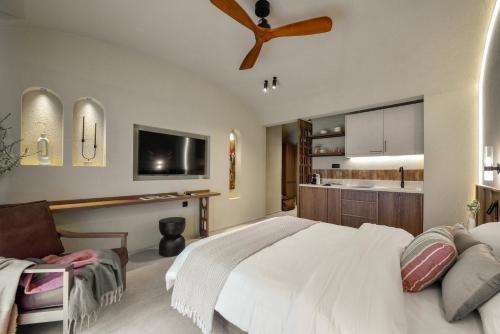a bedroom with a large bed and a kitchen at DOMUS GEORGiO in Litochoro