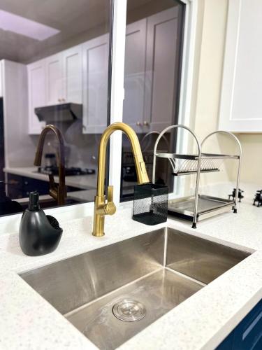 a kitchen sink with two faucets on a counter at Rest and Reset in Usulután