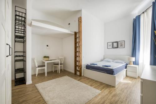 a small bedroom with a bed and a desk at Apartament Centrum in Warsaw