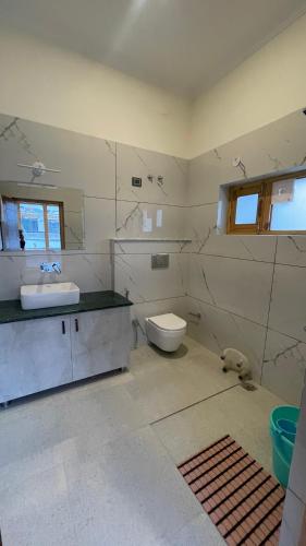 a bathroom with a sink and a toilet at Hotel shaynam in Leh