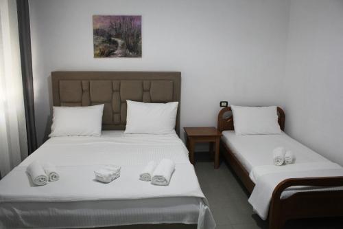 a bedroom with two beds with towels on them at Casa Elefteria & Viron in Himare