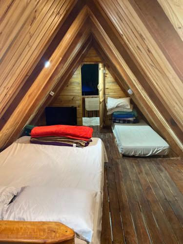 a room with two beds in a attic at Abrigo Pedrão in Pedralva