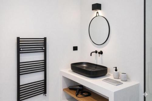 a bathroom with a black sink and a mirror at Villa Irene Tolo in Tolo