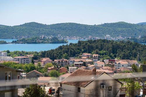 a view of a town with a lake and buildings at Stars Apartments in Tivat