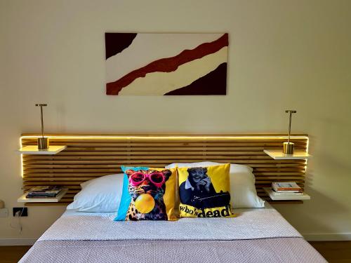 a bedroom with a bed with a wooden headboard at Feel B&B and more in Saluzzo