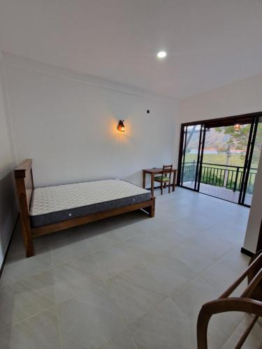 a bedroom with a bed and a balcony at OASIS Victoria Lounge! in Kandy