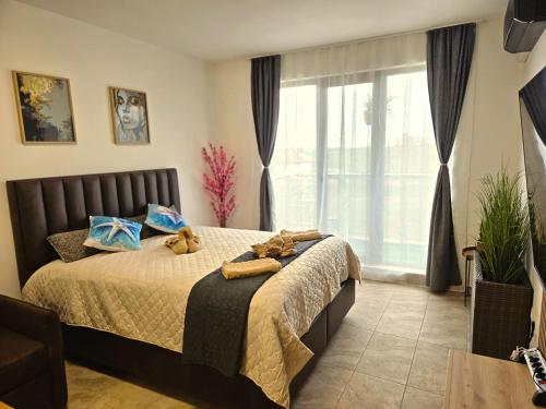 a bedroom with a bed with two teddy bears on it at Nelly's Place 27 in Shkorpilovtsi
