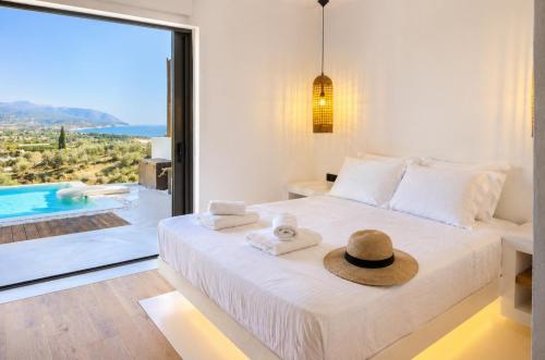 a bedroom with a bed with a hat on it at Villa Irene Tolo in Tolo