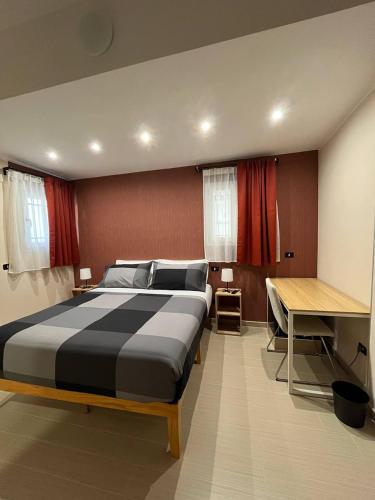 a bedroom with a large bed and a desk at B&B Bagnara Vista Mare in Bagnara Calabra