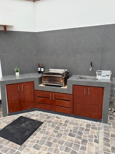 a kitchen with a counter top and a sink at Los Pulpos Beach House in Bombiso