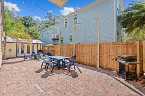 a patio with a table and chairs and a fence at Downtown Gem- Dog Friendly Walk to Everything in St. Augustine
