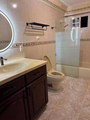 a bathroom with a toilet and a sink and a mirror at Segundo Piso complet in La Cuaba