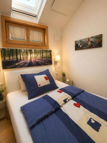 a bedroom with two beds with blue and white sheets at Chalet am Sonnberg in Kleinlobming