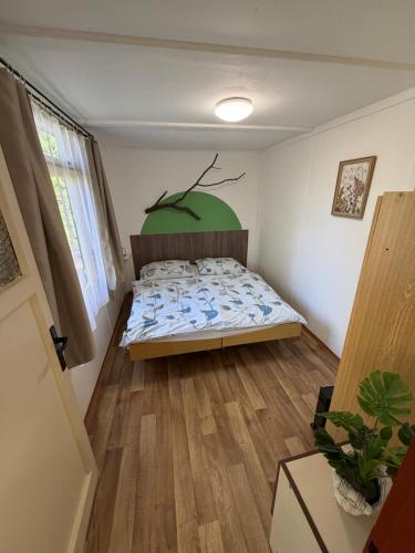 a bedroom with a bed with a tree mural on the wall at Chaty Kašperské Hory in Kašperské Hory