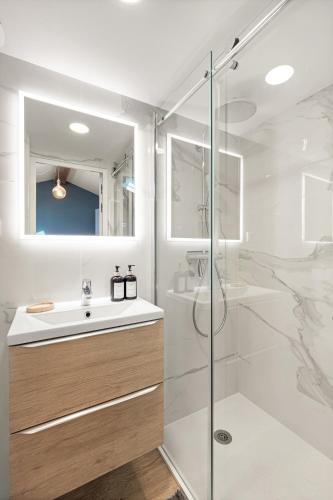 a bathroom with a glass shower and a sink at 10 Rue de la Rampe in Cannes