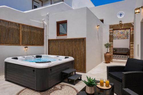a jacuzzi tub in a living room at Antica Casa Dei Nonni with Heated Jacuzzi in Archangelos
