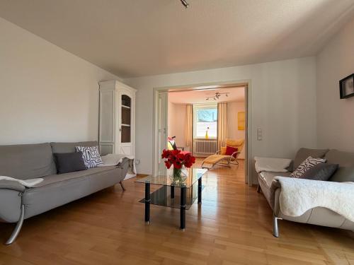 a living room with two couches and a table at Ferienwohnung Sieglinde in Bad Dürrheim