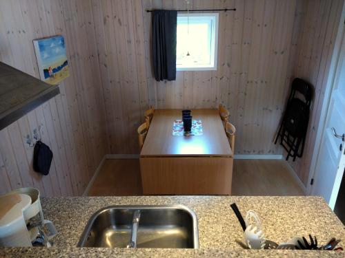 a kitchen with a sink and a counter top at Tornby Strand Camping Cottages in Hirtshals