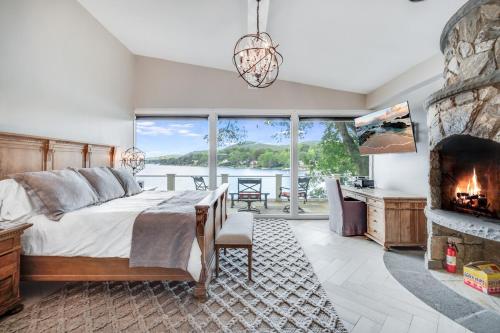 a bedroom with a bed and a fireplace at Waterfront Lakehouse in New Fairfield