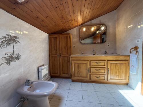 a bathroom with a sink and a toilet and a mirror at Haramburua in Macaye