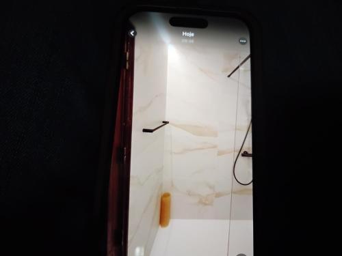 a cell phone is leaning against a wall at Nice flat in pretty condo in Quarteira