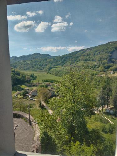 a view of a valley with a tree and mountains at Casina Borgo Castello in Civitella di Romagna