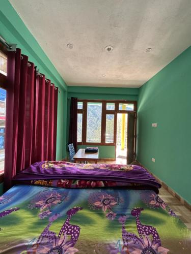 a bedroom with a bed with a purple comforter at Blue Heaven Tosh in Tosh