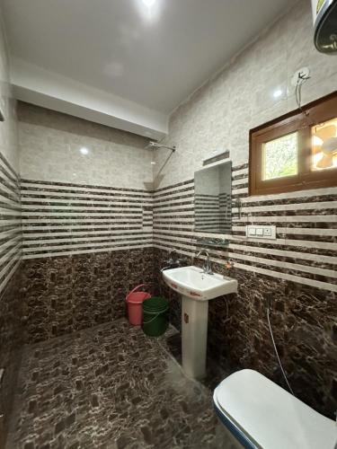 a bathroom with a sink and a toilet in it at Blue Heaven Tosh in Tosh