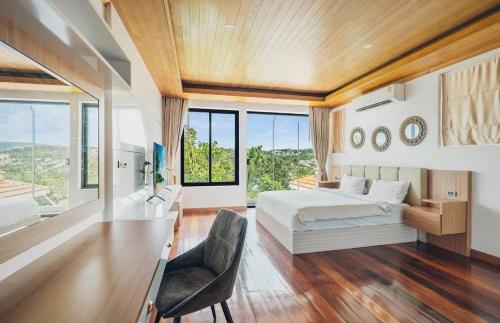 a bedroom with a bed and a chair and windows at Anara Pool Villa - Private House in Bophut