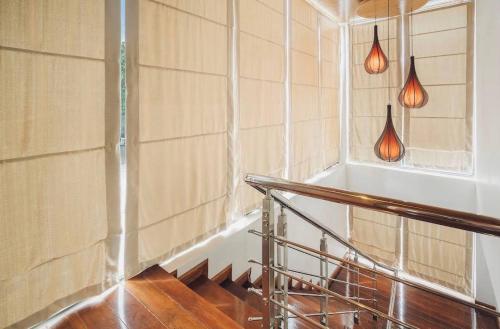 a staircase in a room with a window and lights at Anara Pool Villa - Private House in Bophut