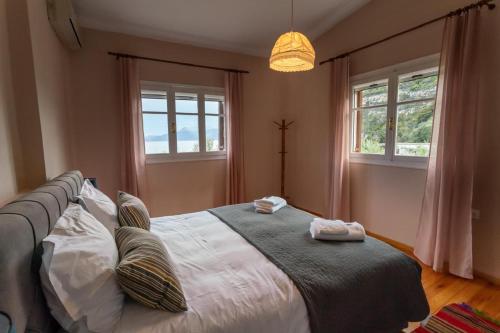 a bedroom with a bed with two towels on it at FantaSea Evgenia in Sampatiki