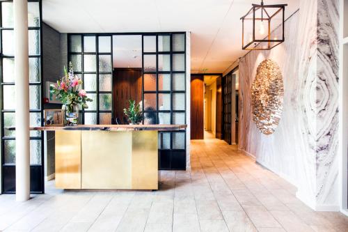 a lobby of a hotel with a reception desk at Restaurant Hotel Merlet in Schoorl