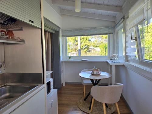 a small kitchen with a small table and a window at Villa Lucy Eco Friendly in Fontane Bianche