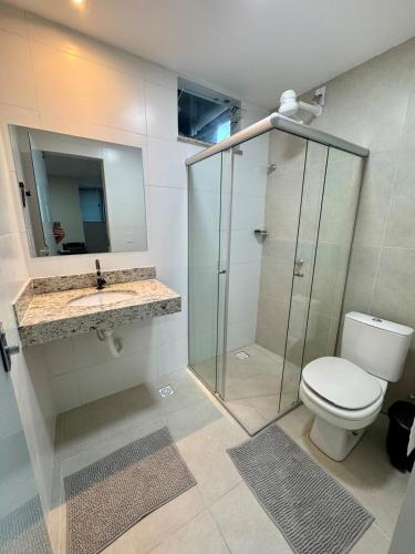 a bathroom with a shower and a toilet and a sink at No centro, em frente à praça in Eunápolis