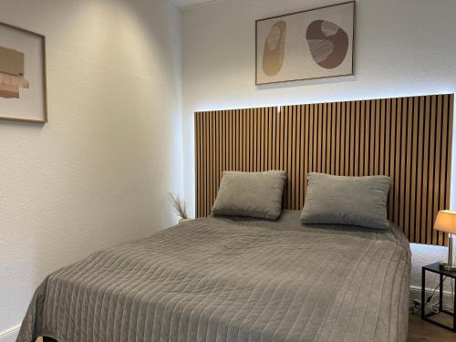 a bedroom with a bed with two pillows on it at Nahe Schlosspark Husum in Husum