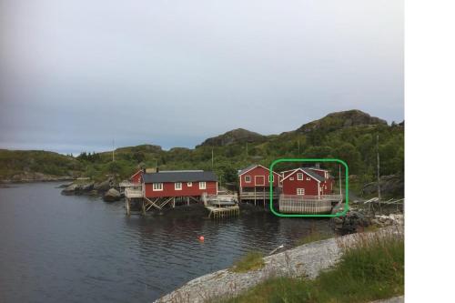 a group of houses on a body of water at Rorbu in Nusfjord, Lofoten in Nussfjord
