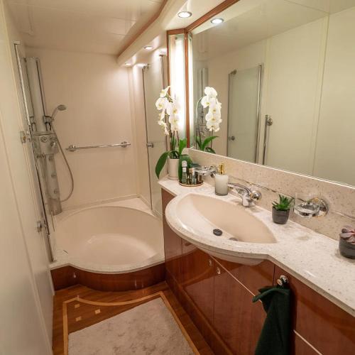 a bathroom with a sink and a shower and a tub at The Lux Yachts - Luxury Private Yacht Experience in Helsinki
