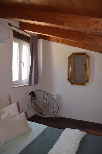 a bedroom with a bed and a mirror on the wall at La cesa country B&B in Scandriglia